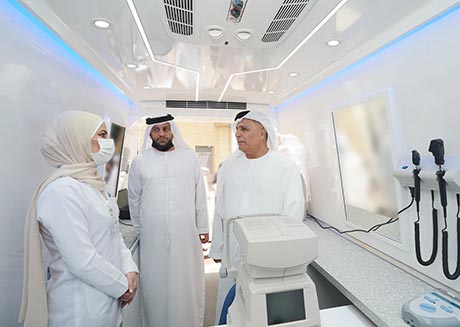 an image of Al Tayer inspecting the mobile eyesight testing vehicle