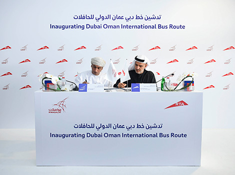 an image Ahmed Bahrozyan and Ahmed bin Ali Albulushi signing the agreement.