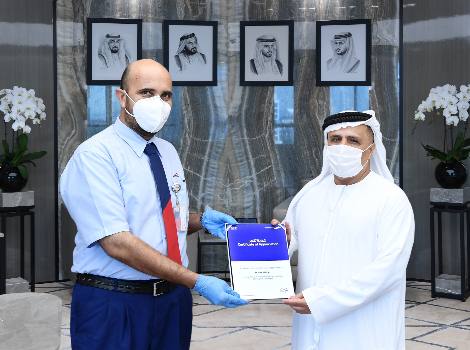 an image of Al Tayer honouring Noor Khan for his job dedication