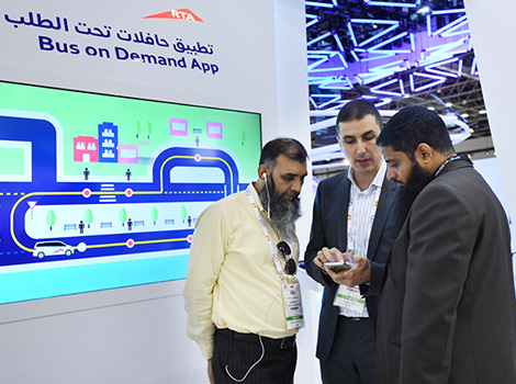 an image of an RTA employee demonstrating the Bus on demand app in Gitex 2017 