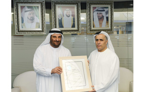 Al Tayer receiving copy of the Platinum certificate from Al Shaibani