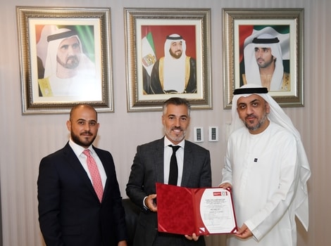 an image of Dr Yousef Mohammed Al Ali CEO of Dubai Taxi Corporation receiving the certificate from Marwan Al Aridi Vice President of the ISO-awarding company,