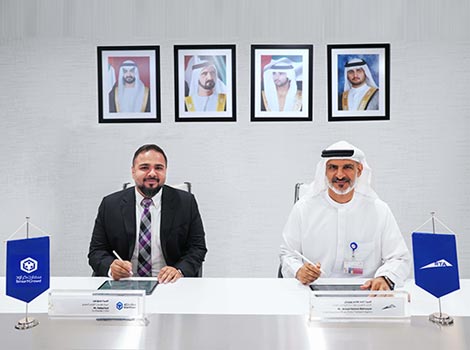 an image of Ahmed Hashim Bahrozyan, and Siddiq Farid, signing the MoU.