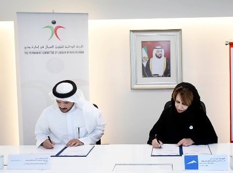 an image of Eng. Maitha bin Adai, CEO of RTA’s Traffic and Roads Agency, and Major General Obaid Muhair bin Sorour while signing the MoU.