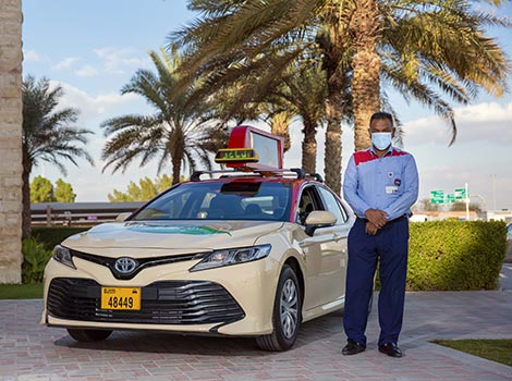 an image of a taxi driver in front of his cabin